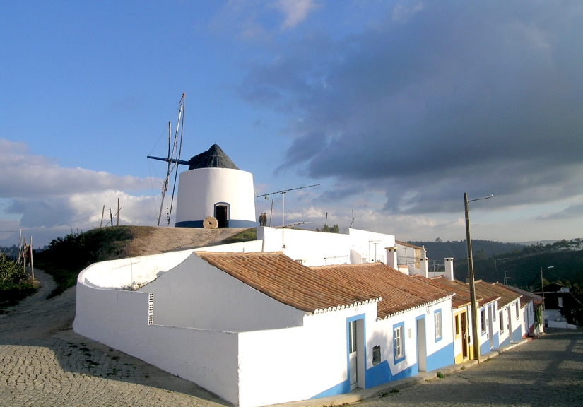 Traditional windmill and houses above the village of Odeceixe on the Algarve's west coast